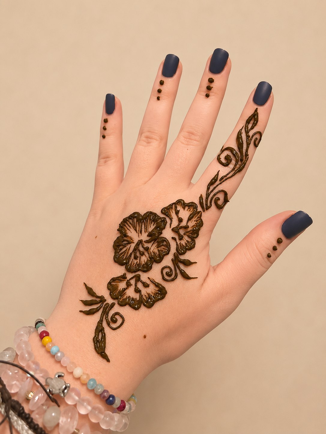 Large hibiscus henna blooms with vine and dot finger detail